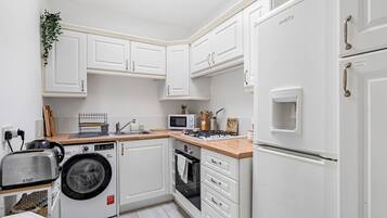 Oven, toaster, cookware/dishes/utensils, dining tables