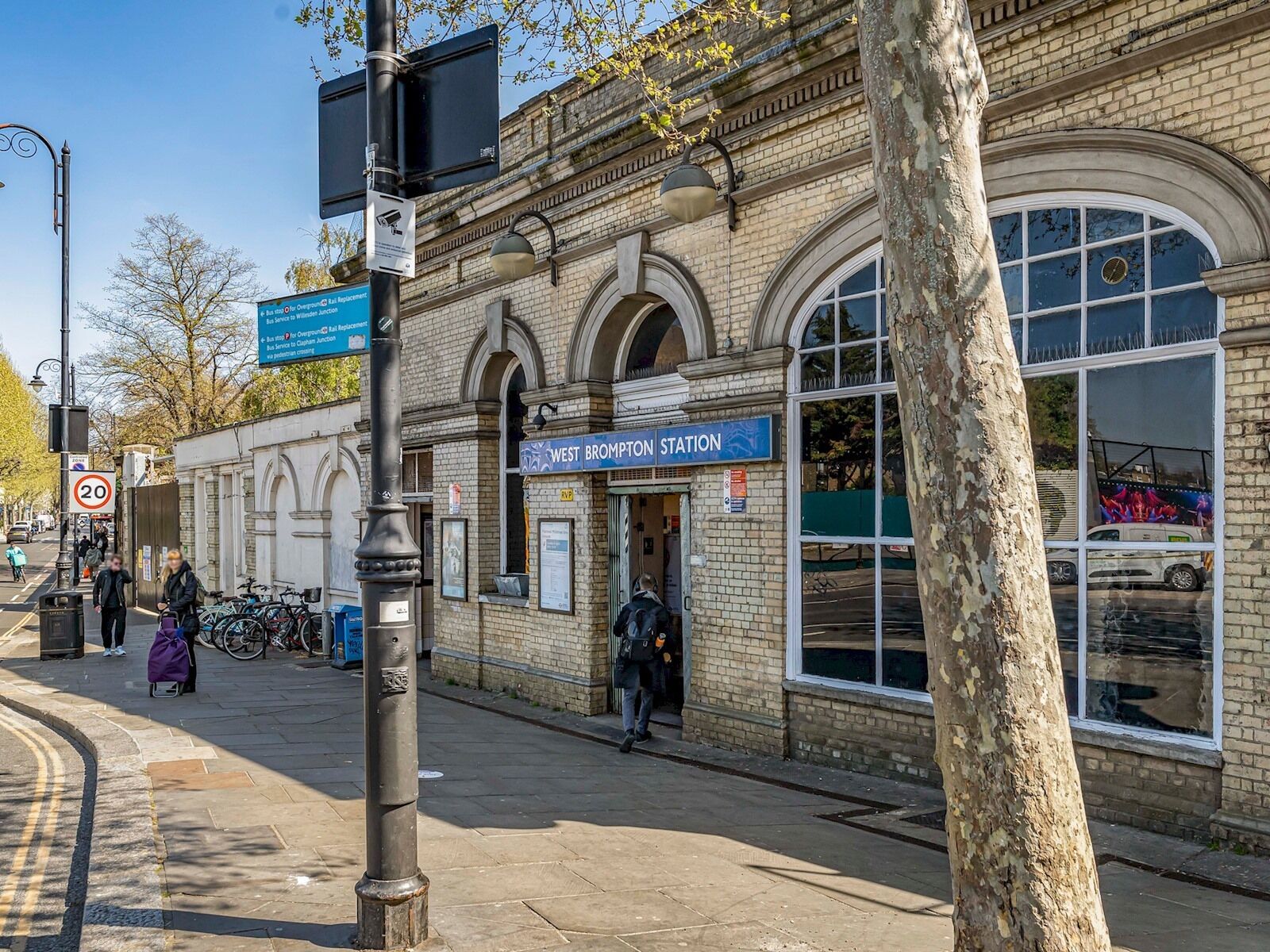 A historic building with a sign reading "West Brompton Station".