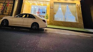 The Creek Gate Hotel at night with a white car parked in front. - CREEK GATE HOTEL (Sharjah)