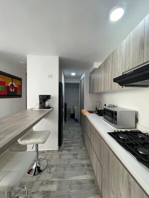 Fridge, microwave, stovetop, coffee/tea maker