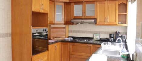 Fridge, coffee/tea maker, toaster, cookware/dishes/utensils