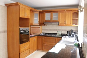 Fridge, coffee/tea maker, toaster, cookware/dishes/utensils