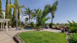 A backyard with a swimming pool, palm trees, a white pergola, and outdoor furniture. - Spacious 5-bedroom tropical paradise resort style pool spa scenic sunset views (Roseville)