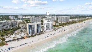 A coastal cityscape with high-rise hotels, a sandy beach, and a clear view of the ocean. - 502 Gorgeous 2 bdrm~ Private Beach ~ Gulf View & Pools ~ Book Sept 21st Special (Destin)