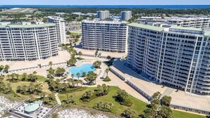 A high-rise hotel with multiple balconies, a central swimming pool, and landscaped gardens. - 502 Gorgeous 2 bdrm~ Private Beach ~ Gulf View & Pools ~ Book Sept 21st Special (Destin)