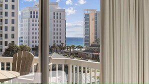 A balcony with a view of a beach and high-rise buildings. - 502 Gorgeous 2 bdrm~ Private Beach ~ Gulf View & Pools ~ Book Sept 21st Special (Destin)