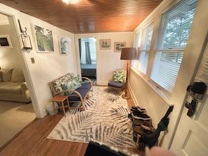 Relax in this inviting living room with a comfortable sofa, small chair, and large rug.