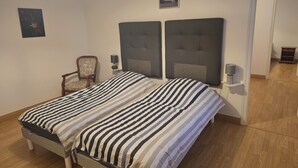 A bedroom with a double bed, a chair, two bedside tables with lamps, a ceiling light, and a framed picture on the wall. - KERYVONNE, FAMILY HOME (Sarzeau)