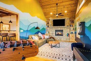Smart TV, fireplace, table football, books