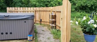 Charming 2-bedroom apartment with outdoor hot tub in rural area, private yard.