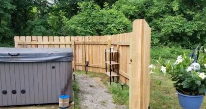 Charming 2-bedroom apartment with outdoor hot tub in rural area, private yard.