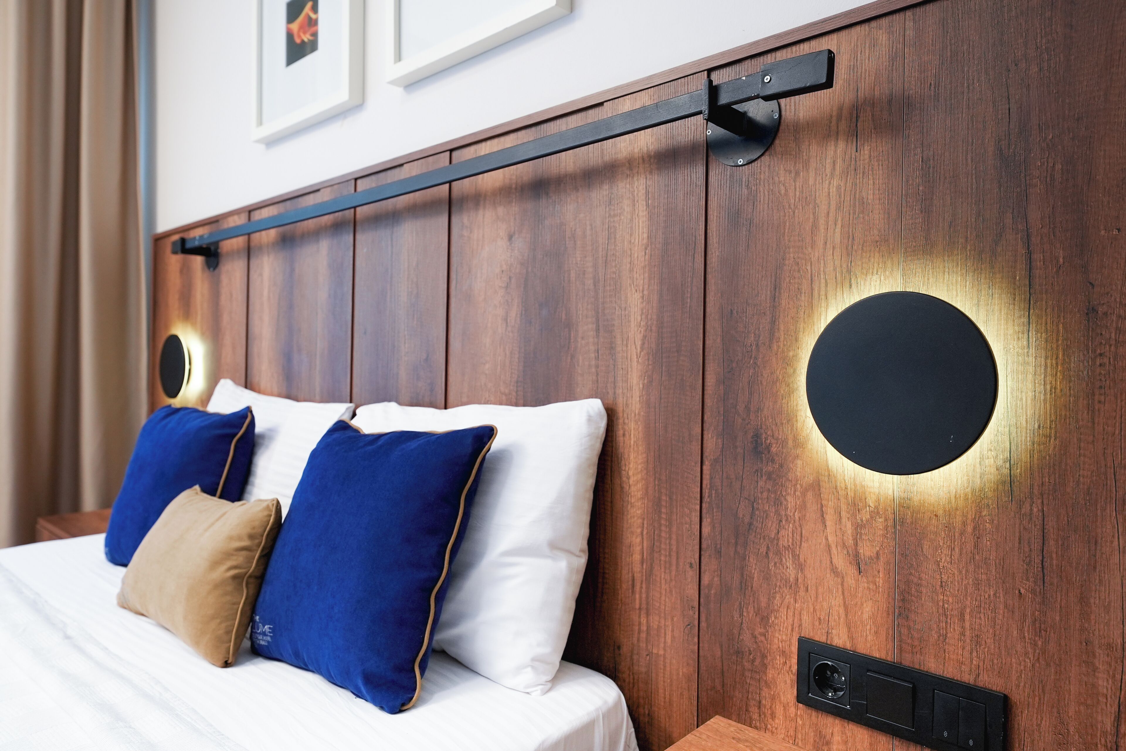 A bed with a headboard, pillows, and a control panel.