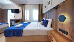 A hotel room with a bed, a TV, a desk, and a wooden headboard. - The Lume Boutique Hotel & Restaurant & Spa (Bodrum)