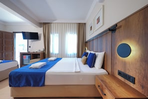 A hotel room with a bed, a TV, a desk, and a wooden headboard. - The Lume Boutique Hotel & Restaurant & Spa (Bodrum)