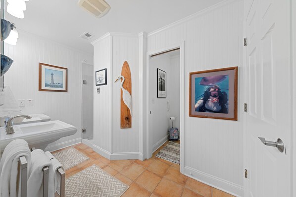 A bathroom with a sink, mirror, and towel rack.