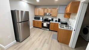 Una cucina moderna con elettrodomestici in acciaio inossidabile, mobili in legno e forno integrato.