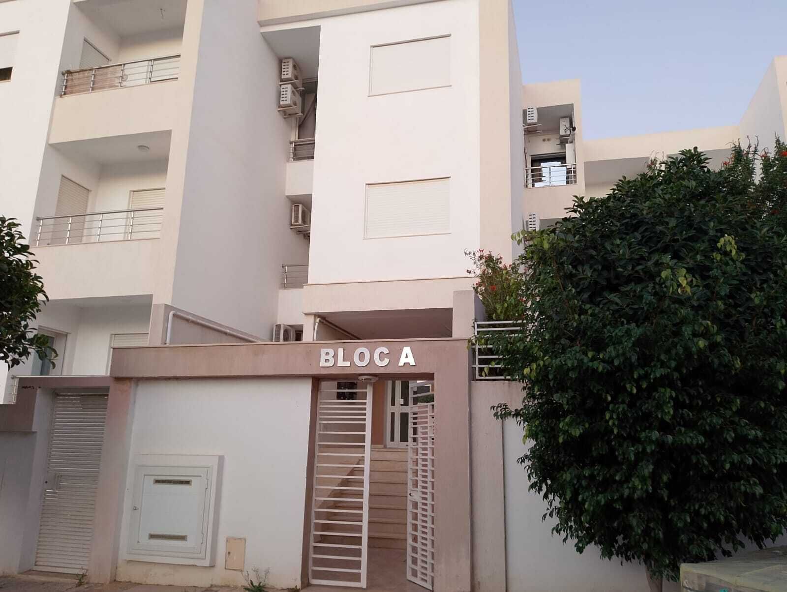 A multi-story building with a sign reading "BLOCA" at the entrance.