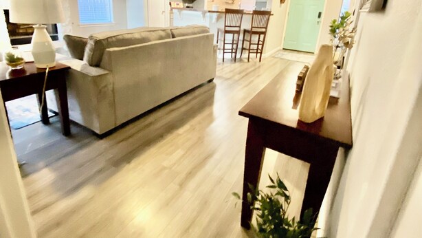 A spacious living area with a sofa, a dining table, and a ceiling fan. - Round Rock - Austin Hideaway (Round Rock)