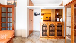 A room with a wooden cabinet, a door, and a tiled floor. - Apartment 'Baldi' with Private Terrace, Wi-Fi and Air Conditioning (Otranto)