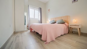 A bedroom with a bed, bedside table, lamp, and a window. - Villa 'Sanctipetri 10 Pax – adults over 25 only' with private pool, Wi-Fi & air conditioning (Chiclana de la Frontera)