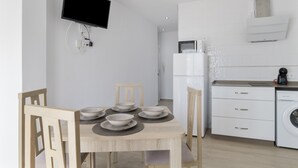 A modern kitchen with white cabinets, a microwave, and a washing machine. - Apartment 'Casa Antonia 2' with Shared Terrace, Wi-Fi and Air Conditioning (Conil de la Fra.)