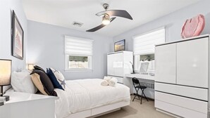A bedroom with a bed, a desk, a chair, and a wardrobe. - 3BR Home - Close to Beach - Backyard Oasis (Margate City)