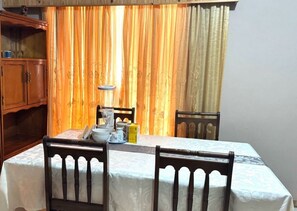 Enjoy a romantic dinner for two in this inviting dining area, complete with a beautifully set table and comfortable seating.