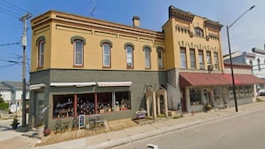 A two-story building with a ground-floor shop and a second-floor residential unit. - Beautiful Century old Apartments-Apt B (Algoma)