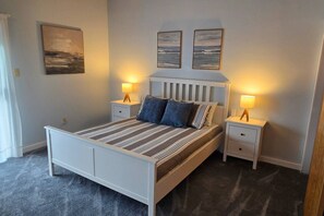 A bedroom with a bed, two bedside tables, a headboard, and two wall-mounted lamps. - Diamond Point~Canal Views! Peaceful with Game Room (Sequim)