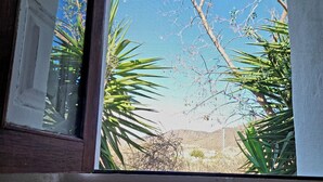 A window with a view of a clear blue sky, a tree, and some foliage. - Casita-1 To 7Guests-Private Pool-Patio-Bbq-Parking (Las Norias, Huercal Overa)