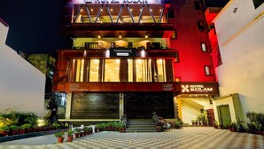 Hotel Kolam with a prominent sign, a Townhouse section, and a checkered pavement area with potted plants. - Classic Hotel Kolam (Dehradun)