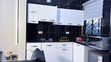 Standard Apartment | Private kitchen | Microwave, oven, stovetop, cookware/dishes/utensils