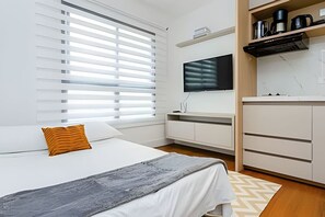 1 bedroom, desk, iron/ironing board, travel crib