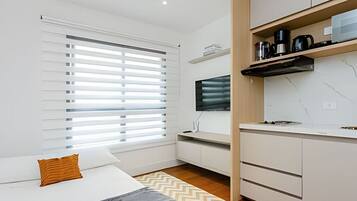 1 quarto, escrivaninha, ferros/tábuas de passar roupa, berço de viagem