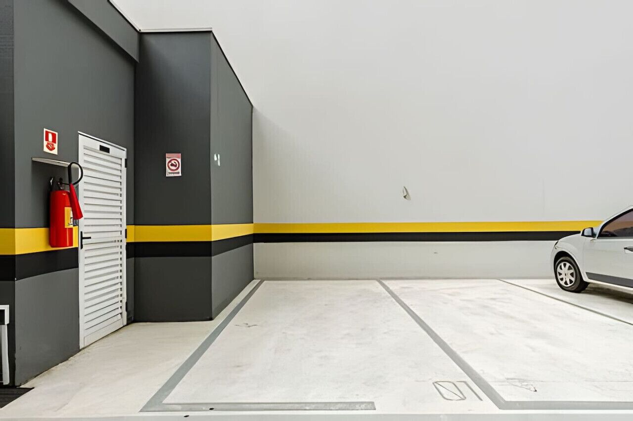 A parking garage with a white car parked inside.