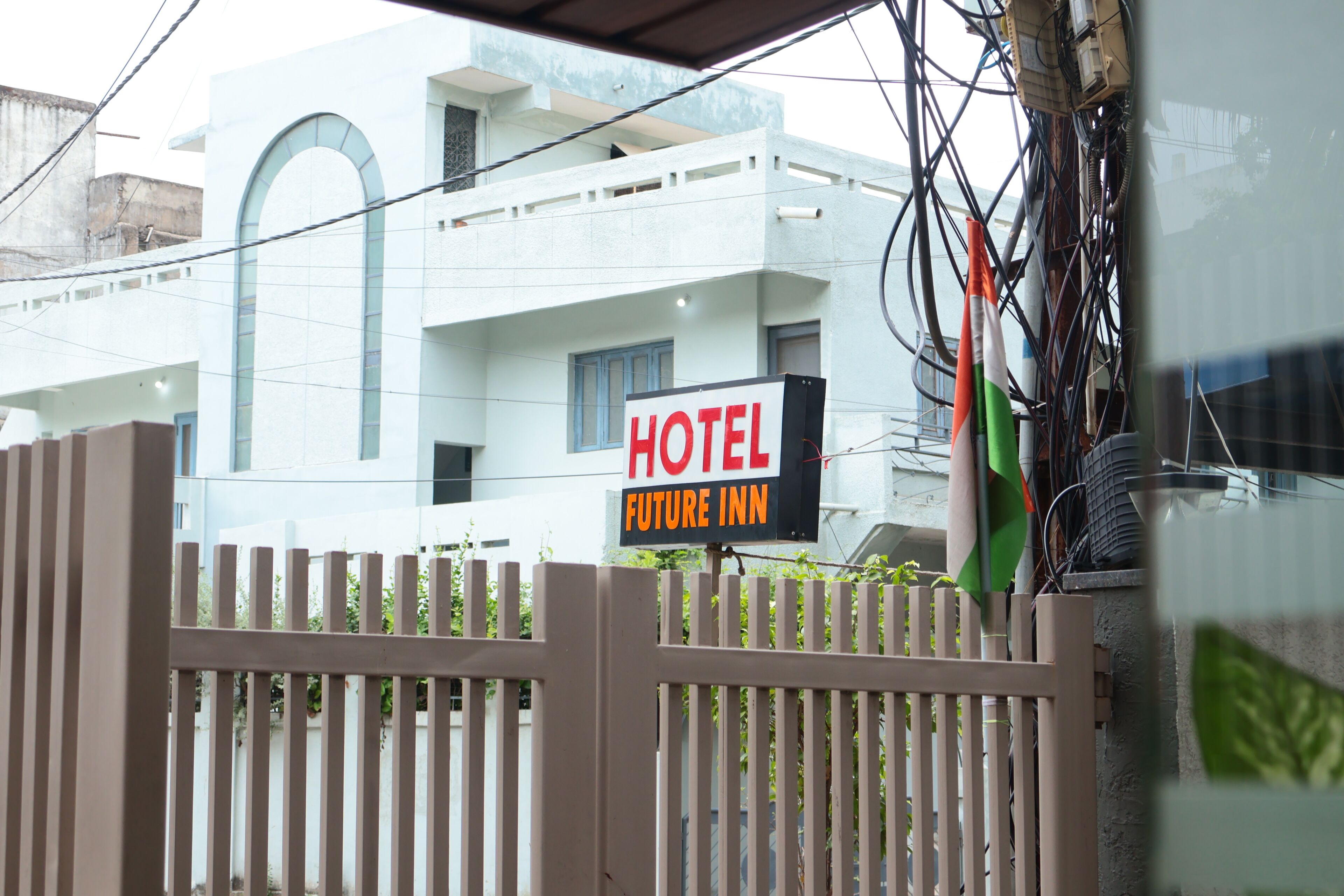 A hotel sign with the name "HOTEL FUTURE INN" on a building.