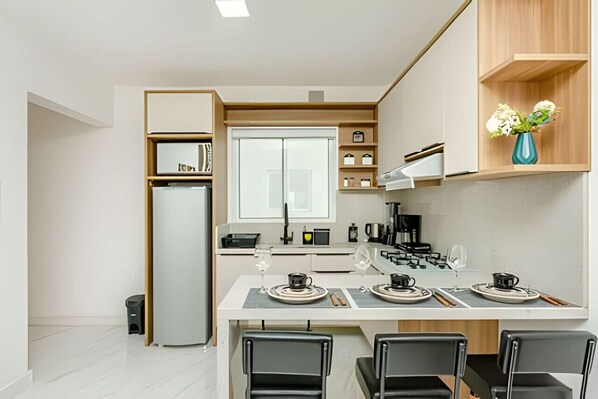 Fridge, microwave, stovetop, coffee/tea maker