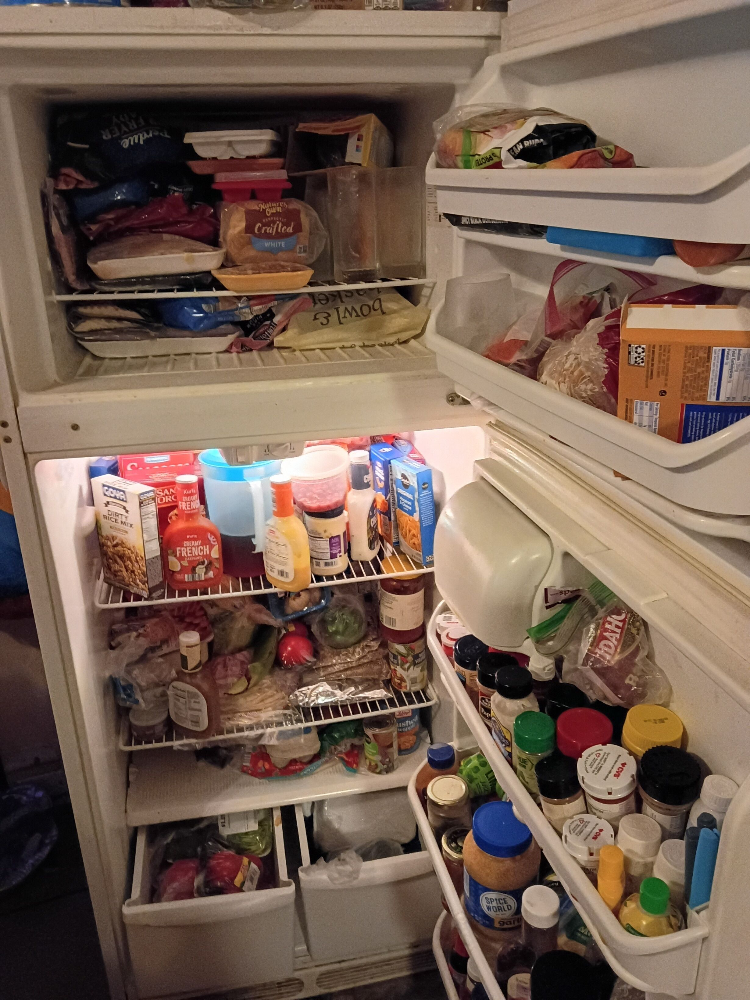 A refrigerator stocked with various food items and condiments.