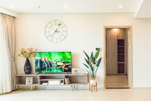 Design Apartment | Living area | Flat-screen TV, books - The Song (Ho Chi Minh City)