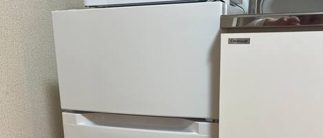 A compact kitchen with a microwave, a refrigerator, and a sink.