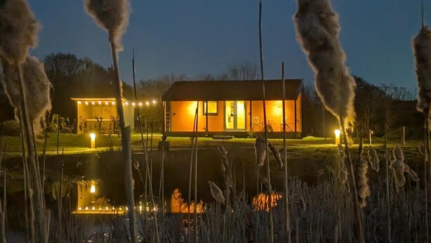 A modern house with a well-lit entrance and a small outdoor area. - Not Available for Rent (Whitchurch)
