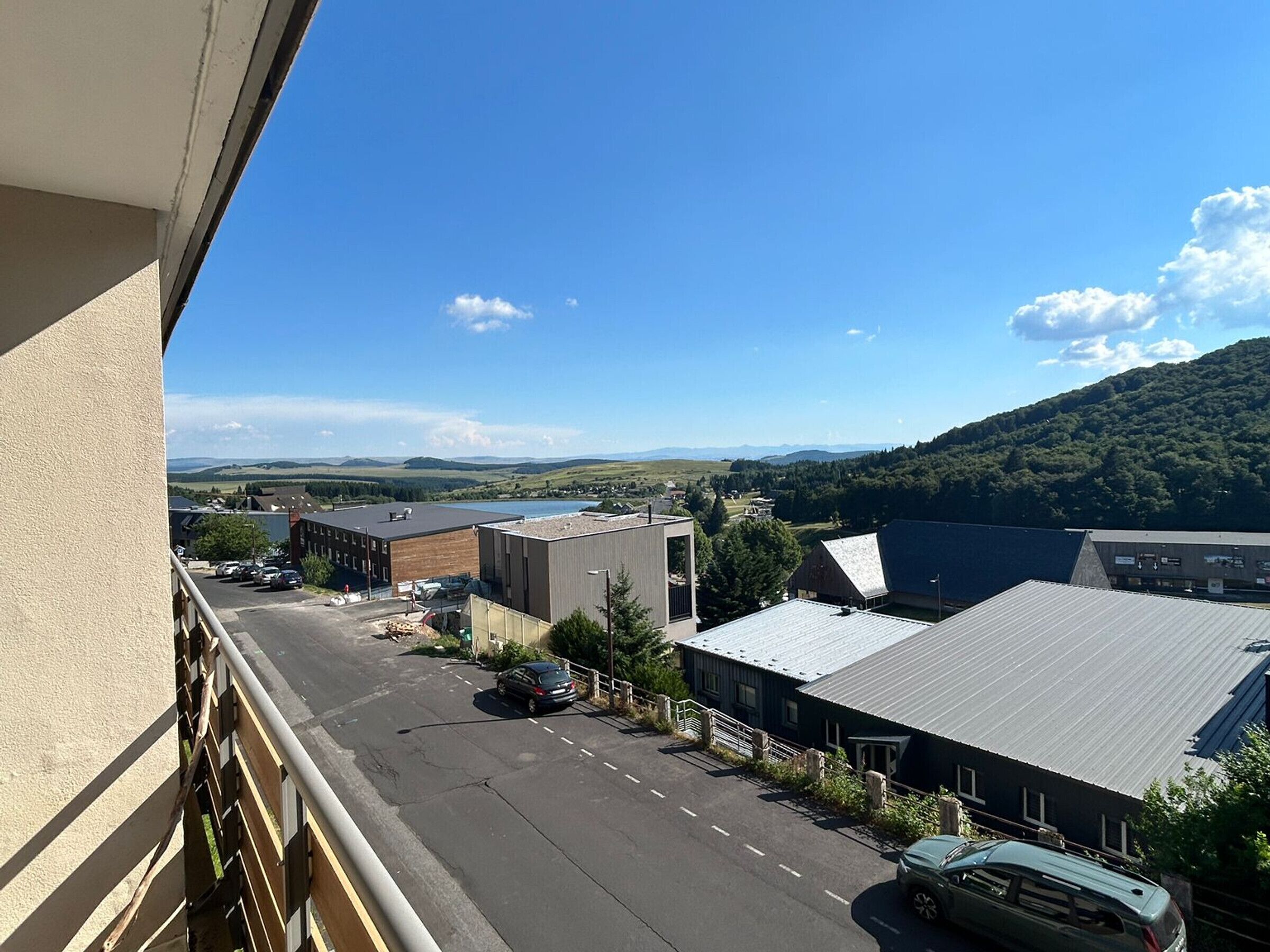 Blick auf eine Stadt mit Gebäuden, einer Straße und einem Berg im Hintergrund.
