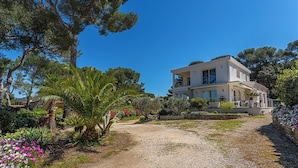 A two-story house with a garden in front.