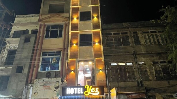 A multi-story building with a prominent 'HOTEL Yes' sign at the ground level. - Hotel yes (Jaipur)