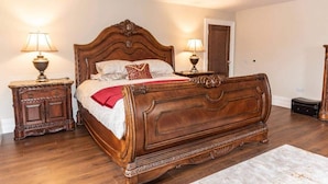 A traditional wooden four-poster bed with a red throw blanket, two bedside tables with lamps, and a marble floor. - Nelly Daly's Barn - Sleeps 6 - Brand New - Parking (Newry)