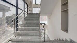 A staircase with metal railings, leading to an upper floor. - Classic HBR Layout Formerly Leela Park (Bengaluru)