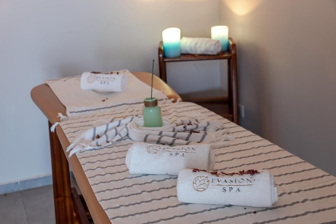 A massage table with towels and a candle, indicating a spa setting.