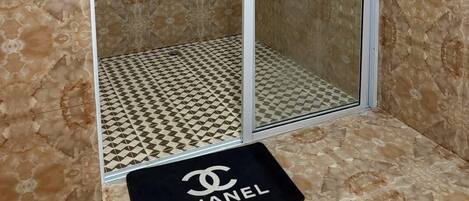 Shower, hair dryer, towels, toilet paper