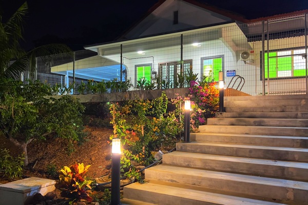 Short, well-lit stairs lead to the main entrance