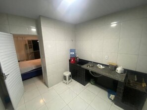 Bathroom features a sink, toilet, and blue water dispenser.
